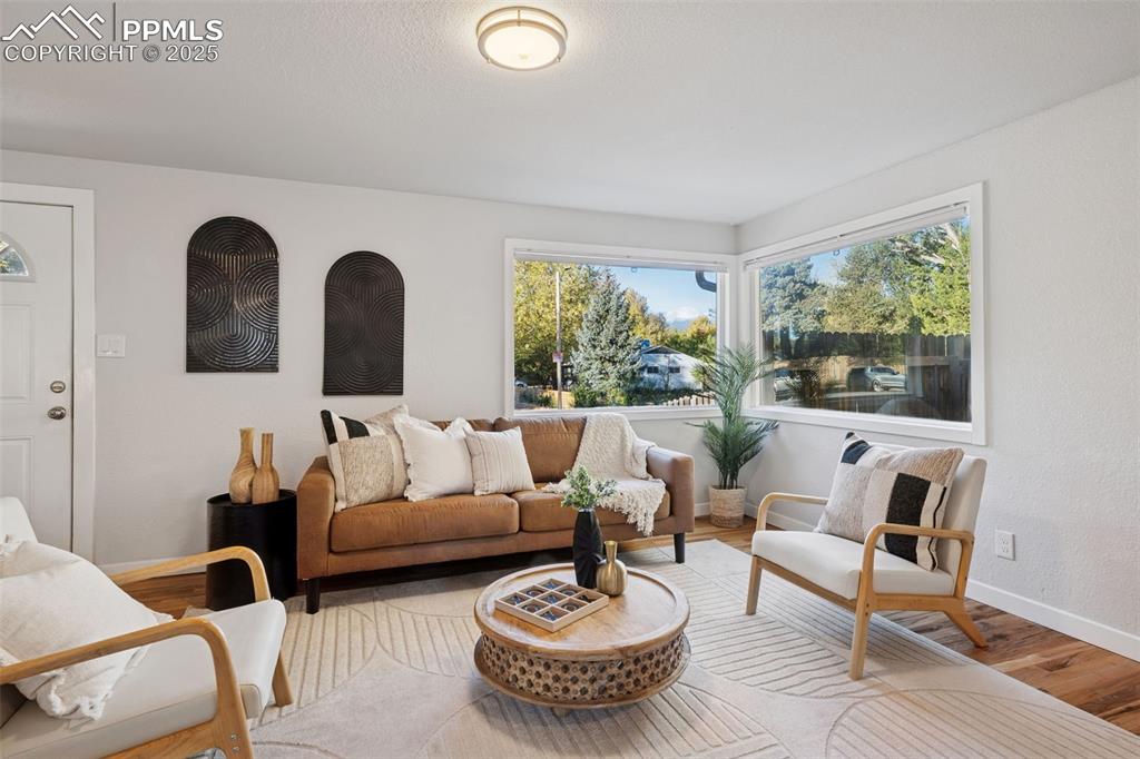 Image 9 of 20: Living room with wood finished floors and baseboards
