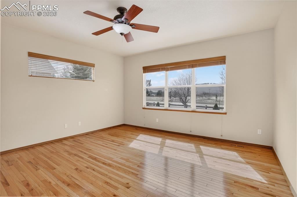Image 10 of 22: Spare room featuring light wood finished floors and a ceiling fan