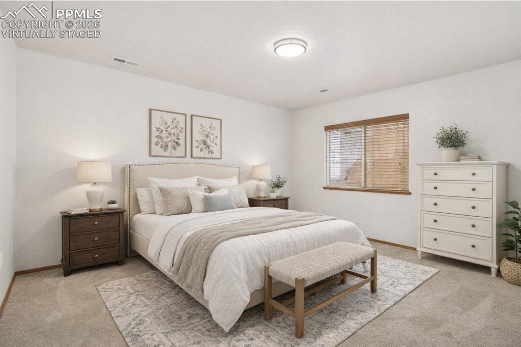 Image 15 of 22: Virtually Staged
Bedroom featuring light colored carpet
