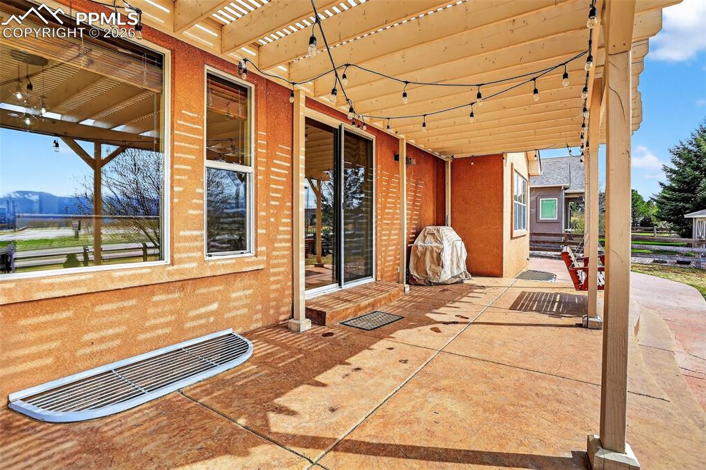 Image 18 of 22: View of patio featuring a pergola and grilling area