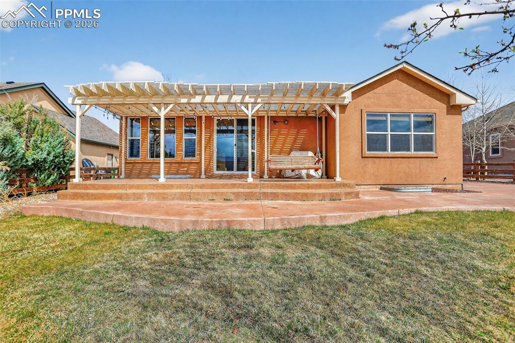 Image 20 of 22: Back of house featuring a patio and stucco siding
