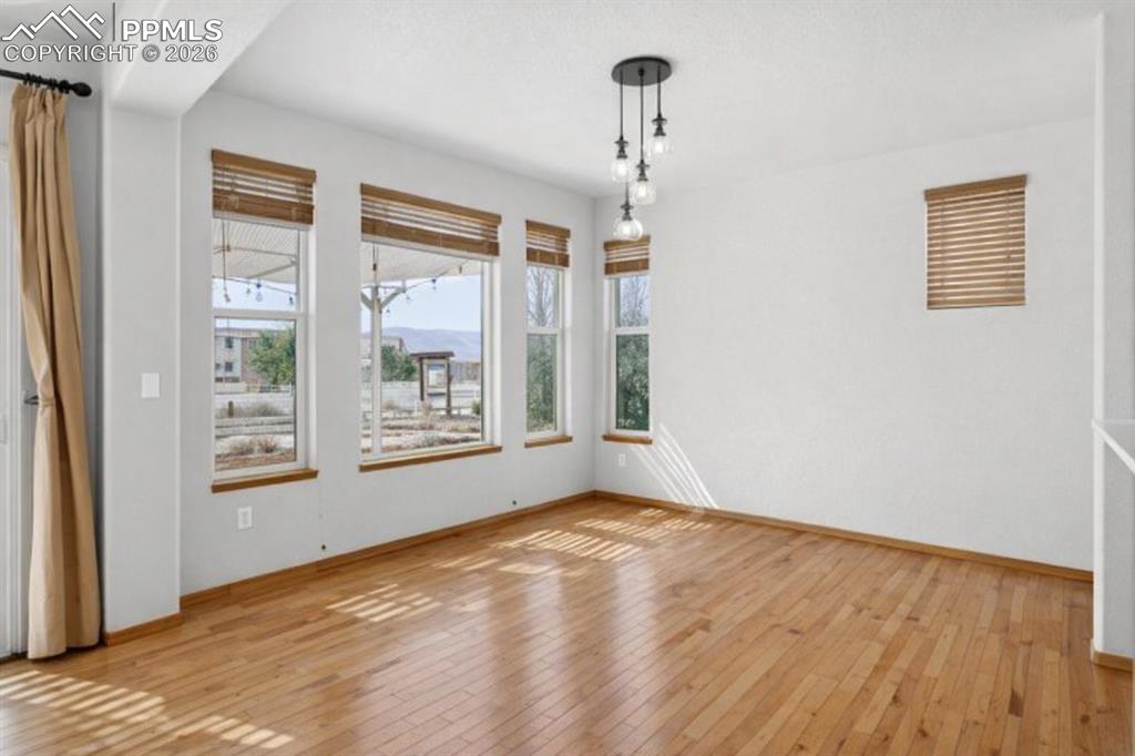 Image 8 of 22: Unfurnished dining area with light wood-style floors and baseboards