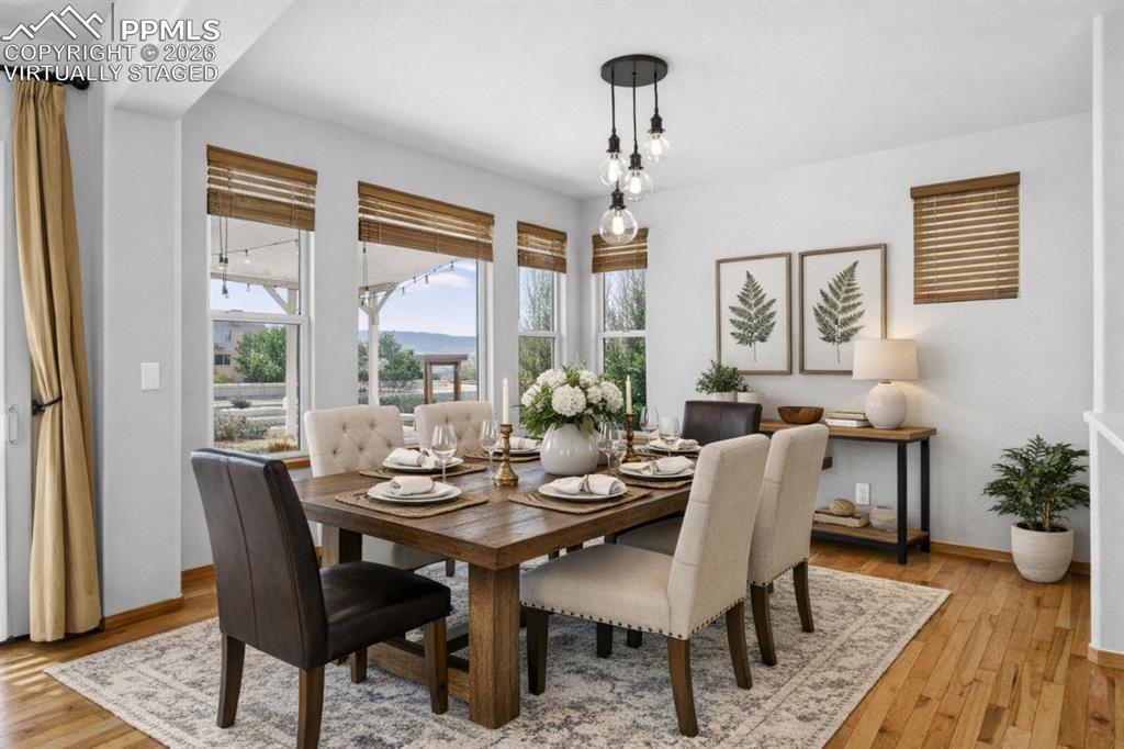 Image 9 of 22: Virtually Staged Dining room featuring light wood-style flooring and basebo