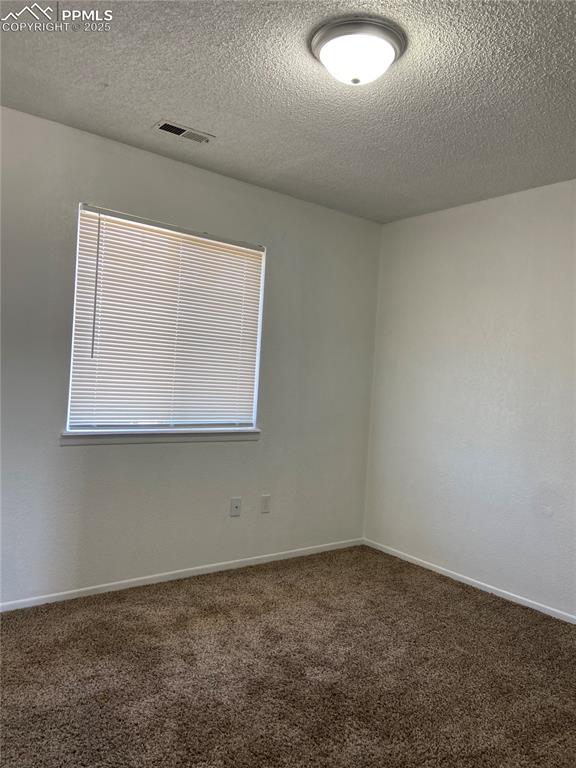 Image 5 of 8: Carpeted bedroom with vinyl window and blinds.