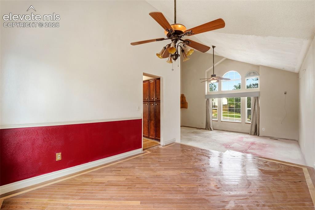 Image 10 of 34: Vaulted ceilings, wood-finish flooring, ceiling fans, and arched windows