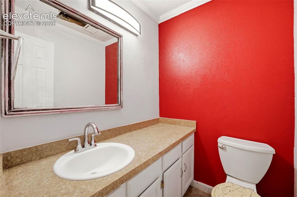 Image 20 of 34: Vanity with an integrated oval sink, chrome-finish faucet, and white cabine
