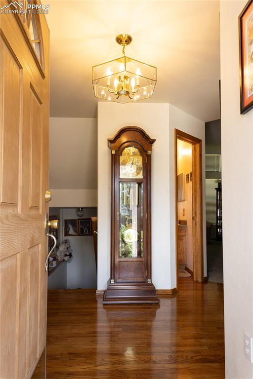 Image 10 of 48: Entrance foyer featuring a chandelier and wood finished floors