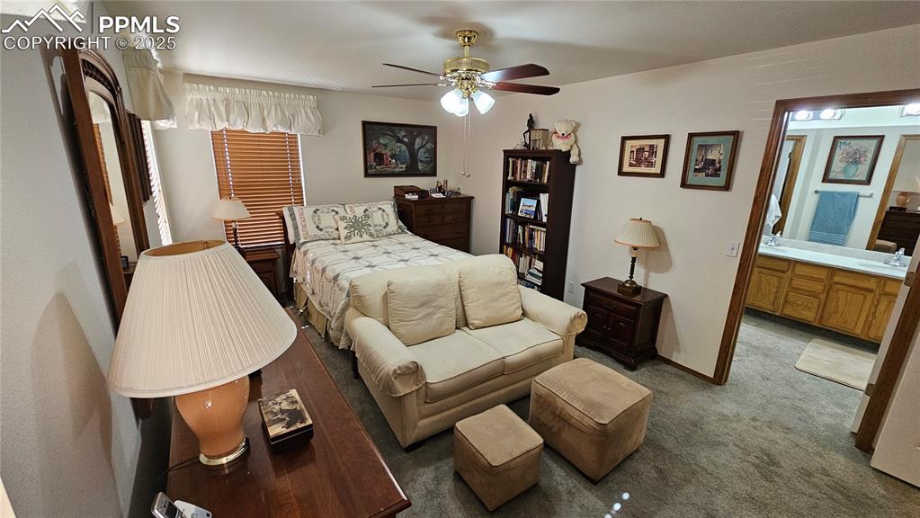 Image 27 of 48: Bedroom with light carpet and ceiling fan