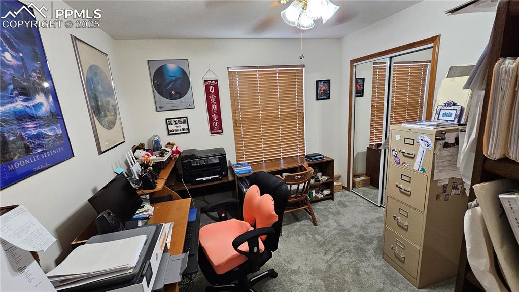 Image 34 of 48: Office area featuring a ceiling fan and carpet flooring
