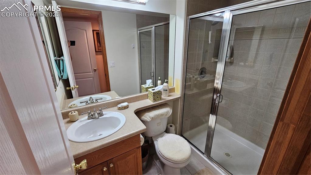 Image 37 of 48: Bathroom with vanity and a stall shower