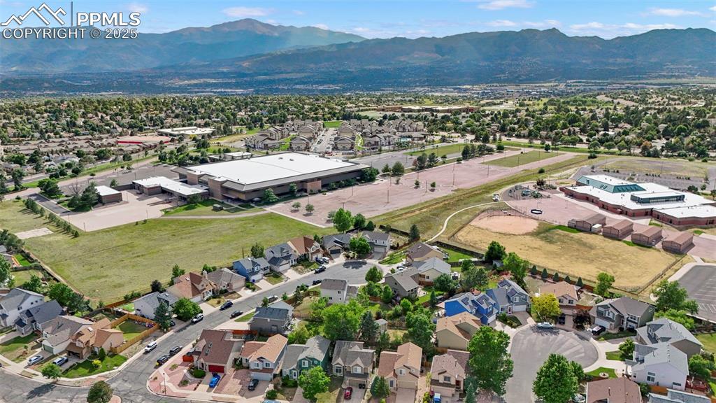 Image 44 of 48: Aerial view of residential area featuring mountains