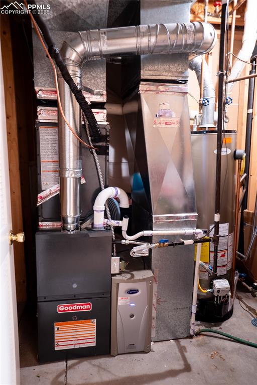Image 47 of 48: Utility room featuring gas water heater
