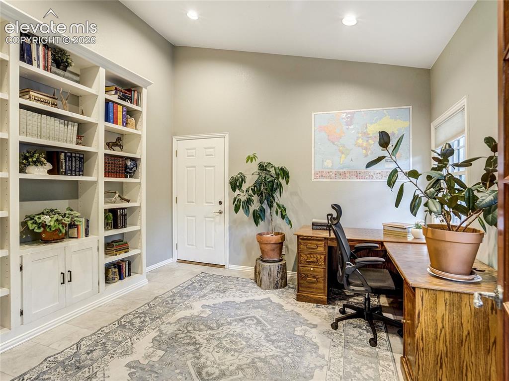 Image 10 of 50: This main level office is located off of the entry and has its own private