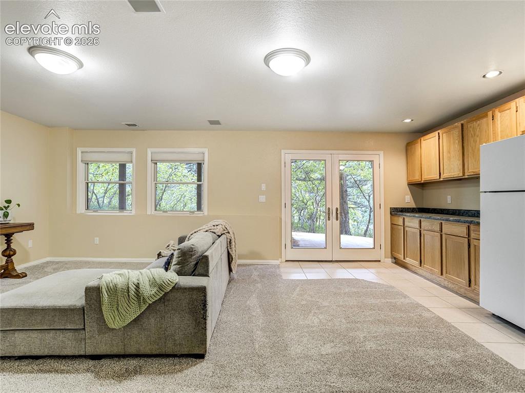 Image 11 of 50: Walkout lower level with a second family room, kitchenette, and its own pri