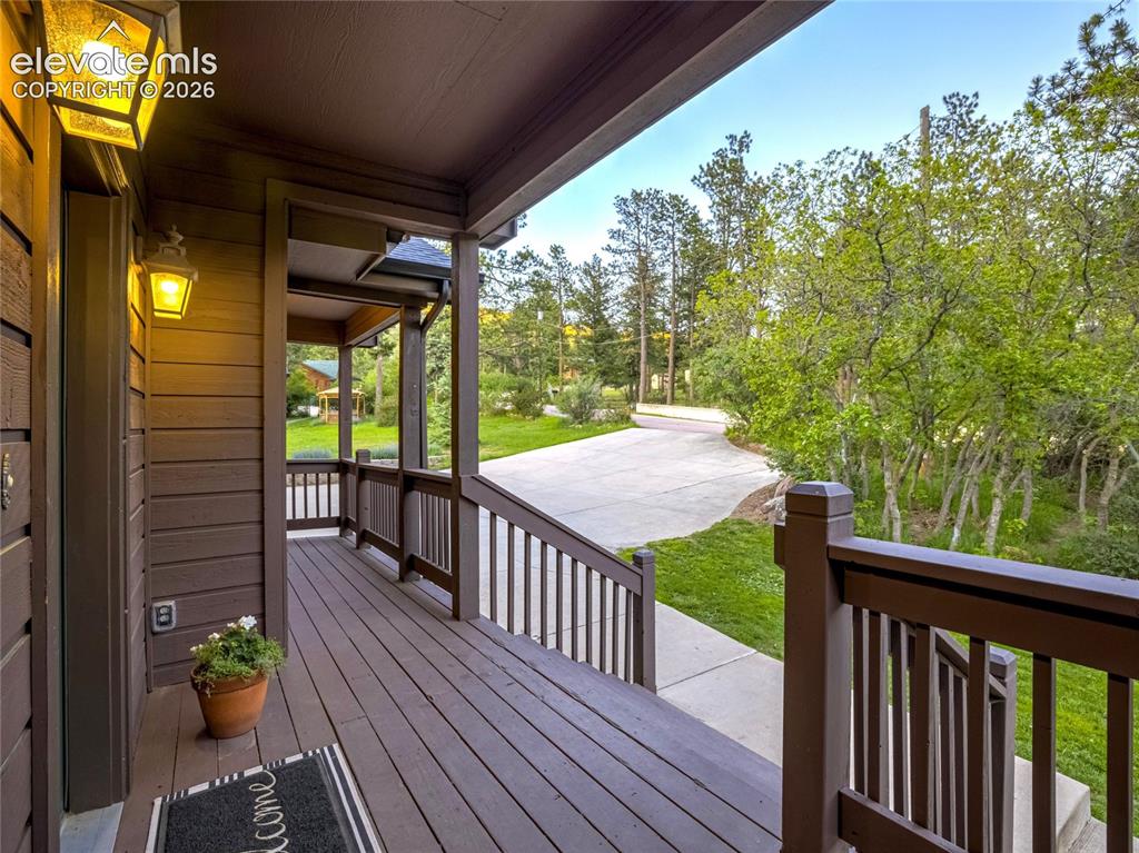 Image 12 of 50: The front porch provides its own sense of warmth in a Rocky Mountain way!