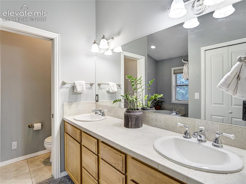 Image 27 of 50: The primary suite’s private 5-piece bathroom