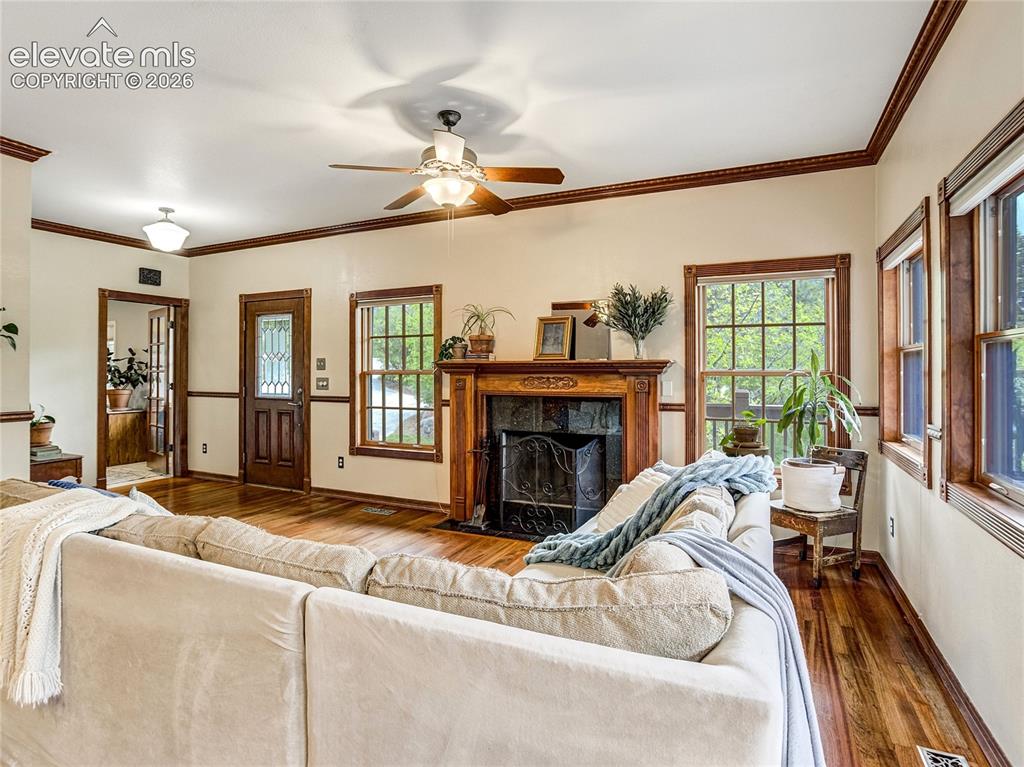 Image 4 of 50: Open-concept living room with fireplace designed for connection and enterta