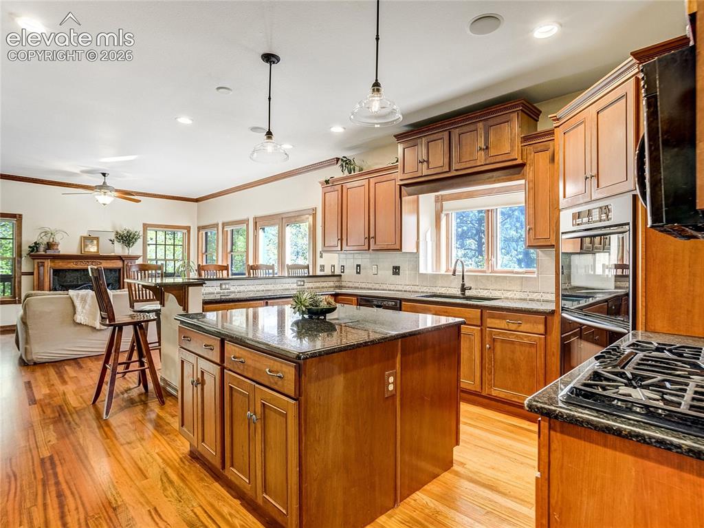 Image 5 of 50: The cook’s kitchen is anchored by the large island and includes a gas range