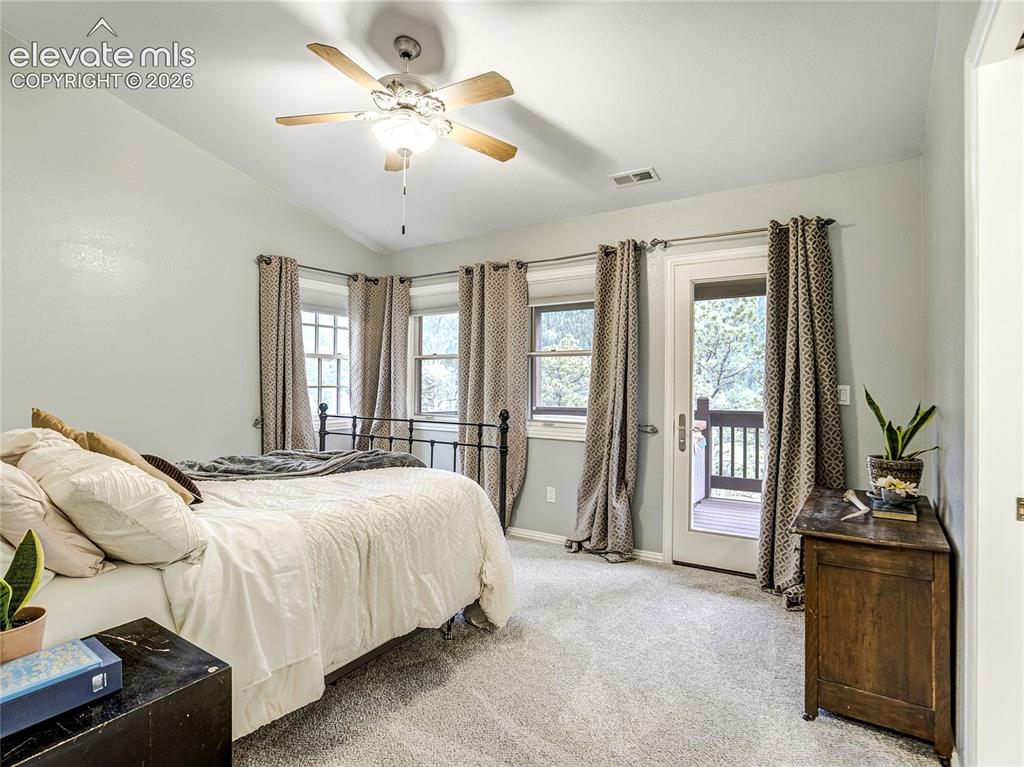 Image 8 of 50: Primary bedroom with a private balcony with hot tub and mountain views that