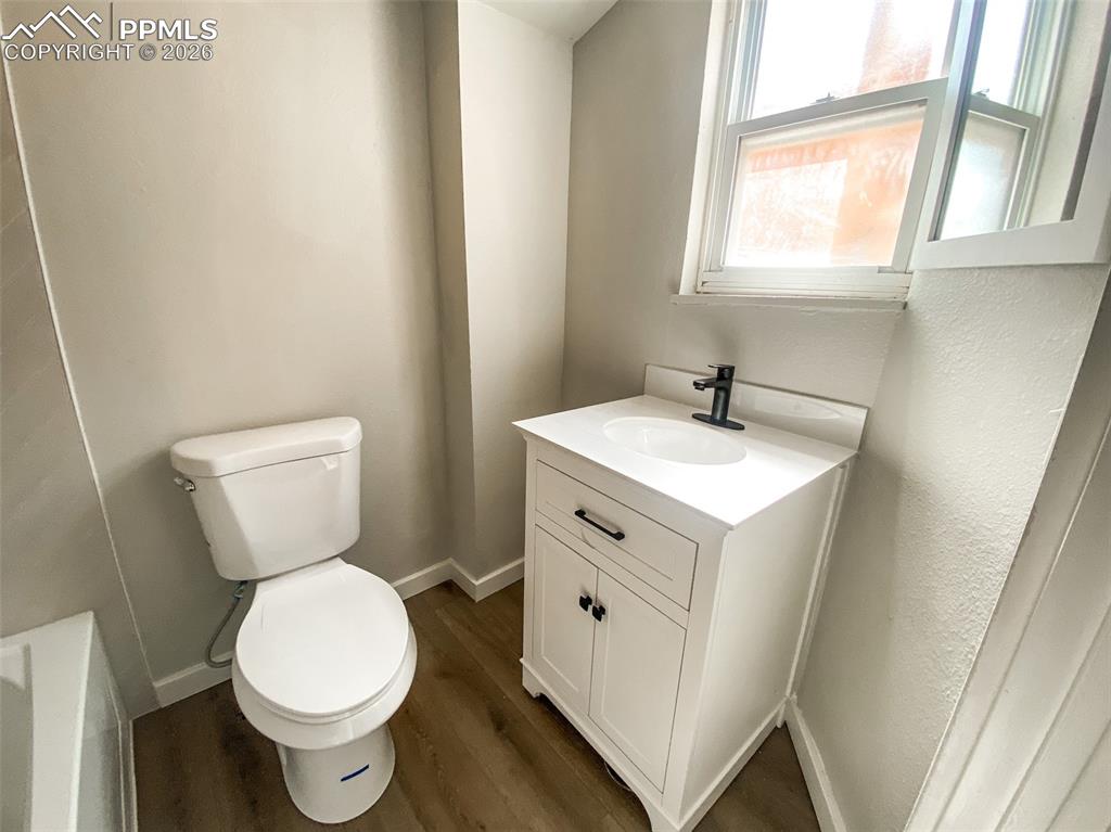 Image 11 of 24: Neutral-toned room with plush carpeting, a single window, white baseboards,