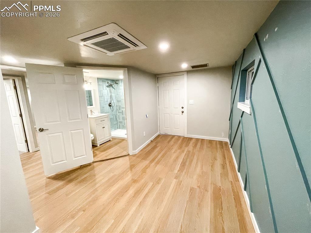Image 15 of 24: Bathroom featuring a walk-in shower with patterned tile surround, white win