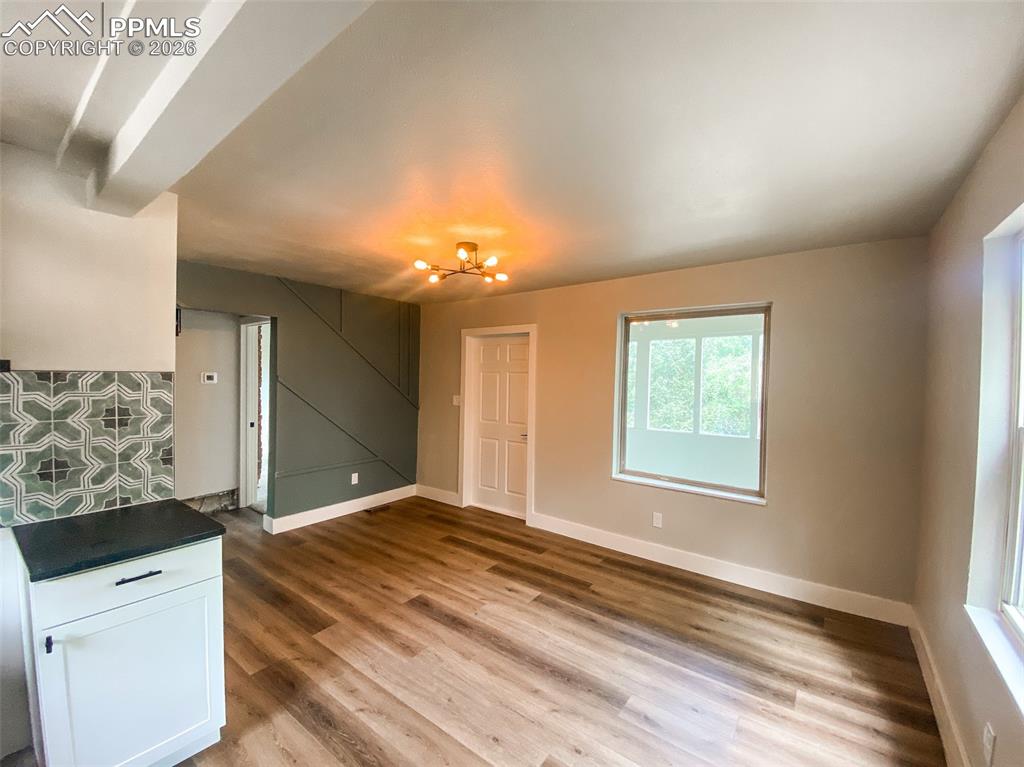 Image 4 of 24: Built-in desk area featuring white shaker-style cabinetry, dark countertops