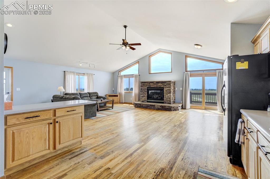 Image 17 of 50: Kitchen featuring light brown cabinets, open floor plan, light wood-type fl