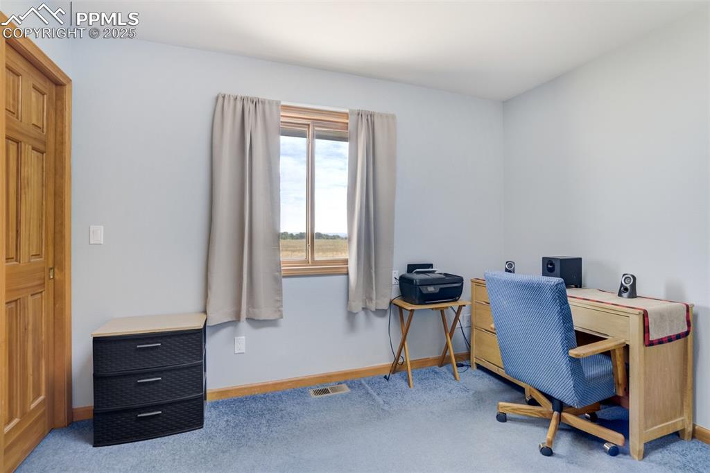 Image 28 of 50: Office space with baseboards and carpet flooring