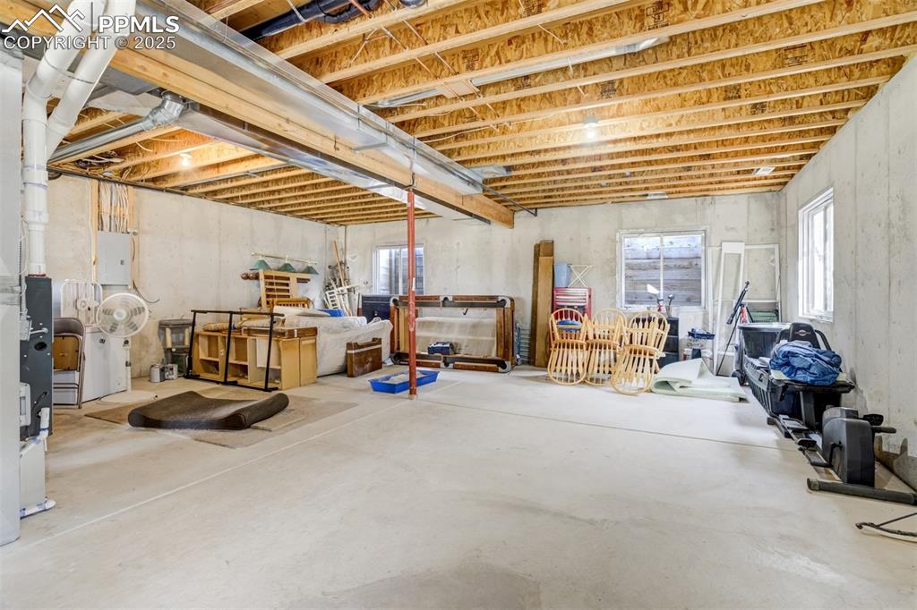 Image 31 of 50: Basement featuring healthy amount of natural light and electric panel