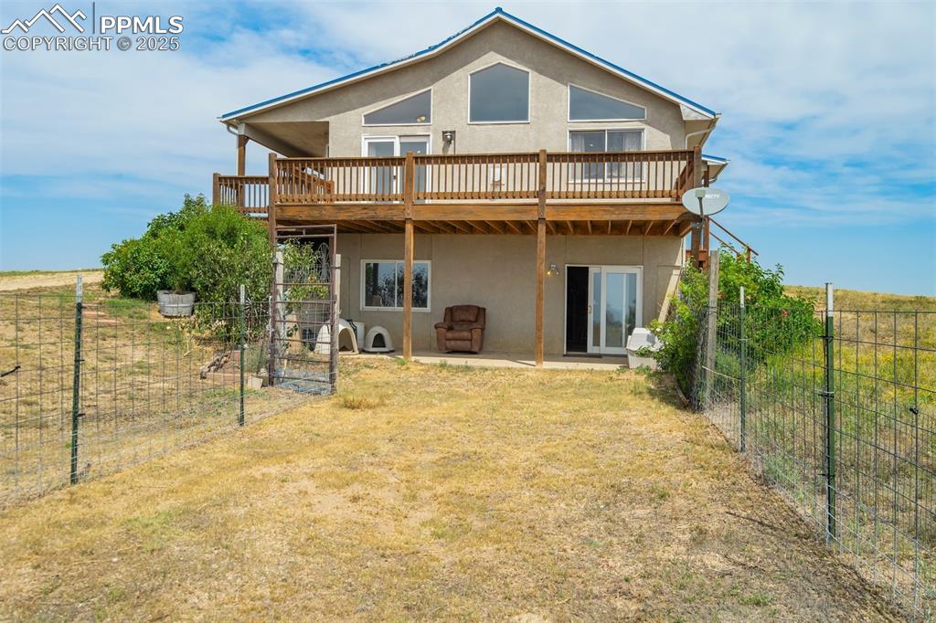Image 34 of 50: Back of property featuring stucco siding, a deck, and a patio area
