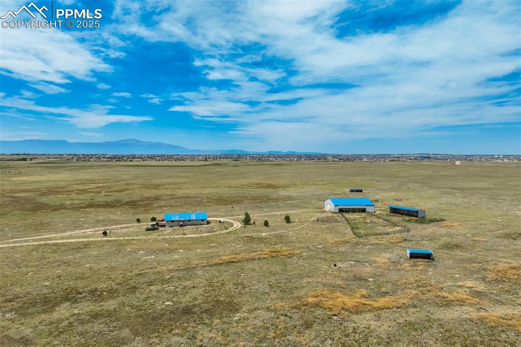 Image 47 of 50: Aerial view of sparsely populated area with a mountain backdrop