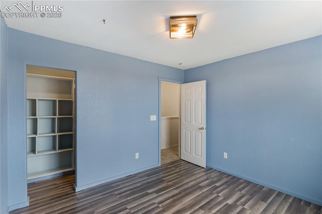 Image 25 of 43: This room features attractive blue walls, wood-look flooring, and a contemp