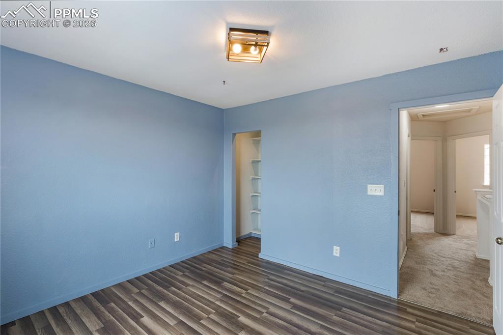 Image 26 of 43: This room features wood-look flooring and a ceiling-mounted light fixture