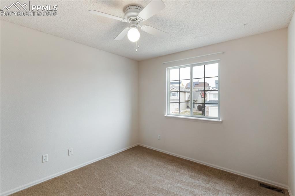 Image 27 of 43: Room with light-colored carpeting, a window providing natural light, and a 