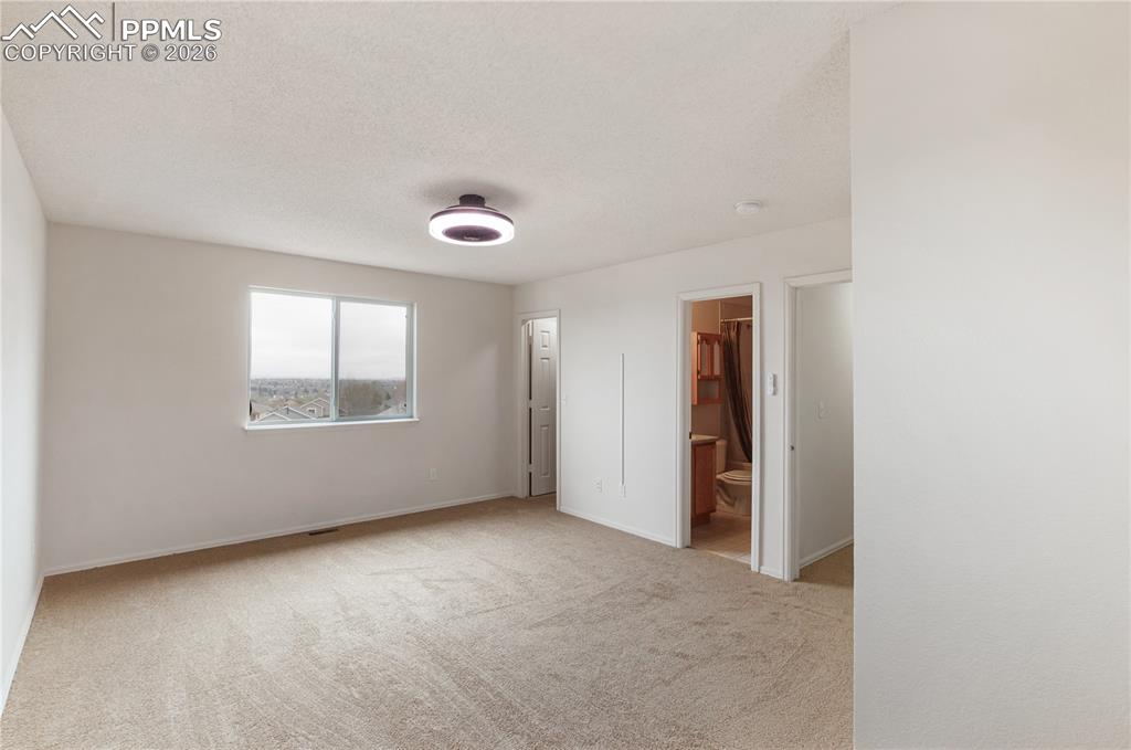 Image 30 of 43: This room features wall-to-wall carpeting, a window providing natural light