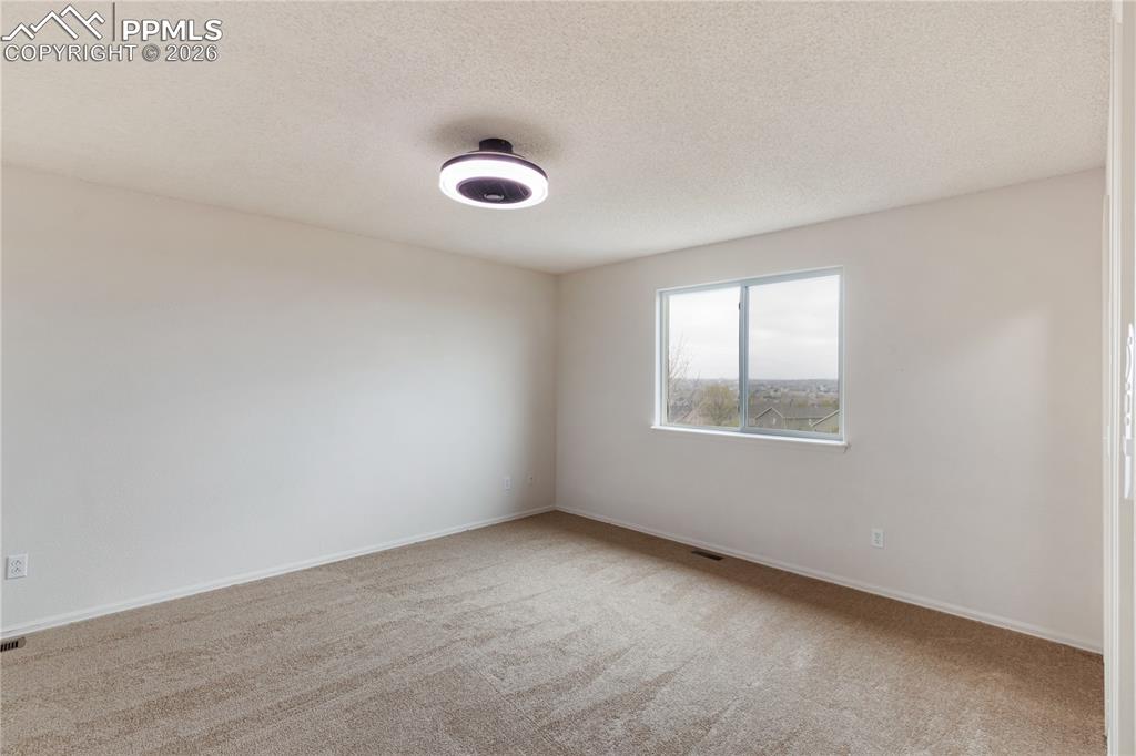 Image 31 of 43: This room features light-colored walls and carpeting, a window providing a 