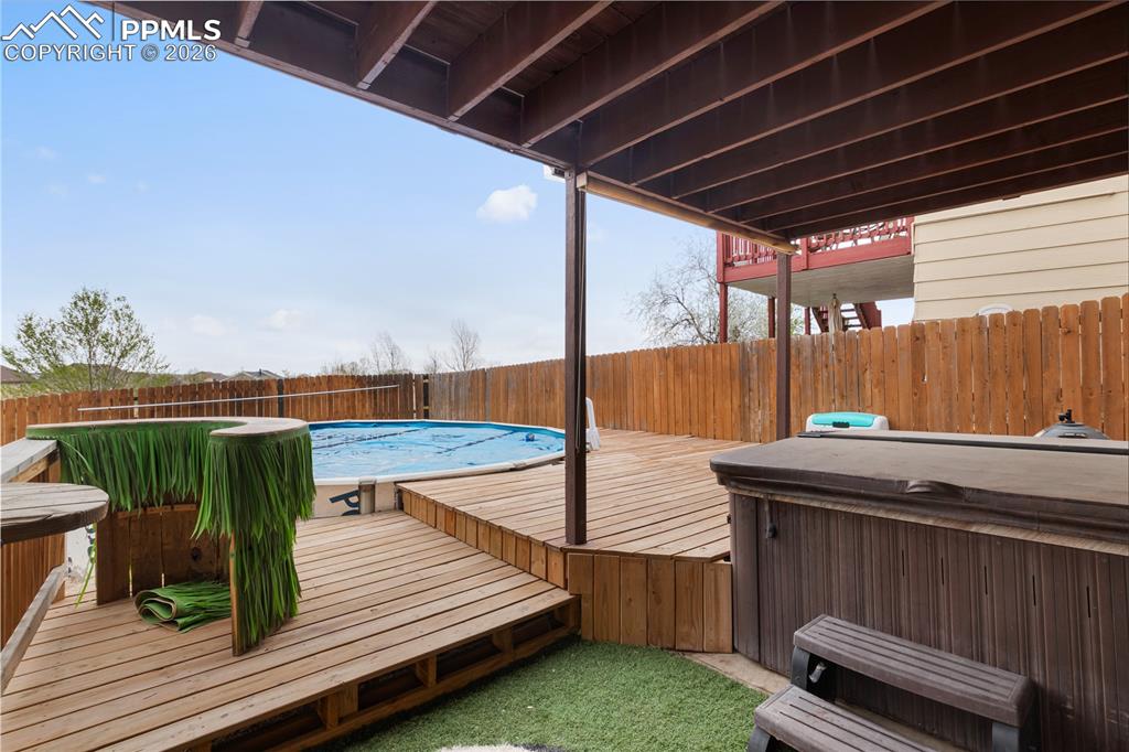 Image 35 of 43: The property features an extensive deck area, complete with a covered secti