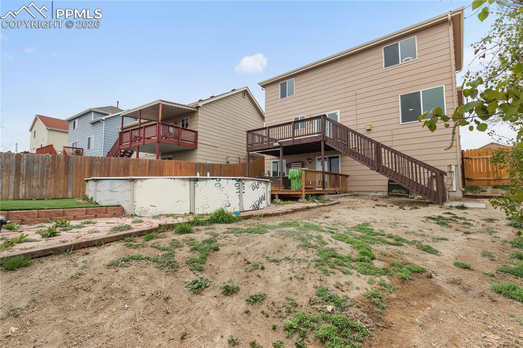 Image 38 of 43: The property features a two-story exterior with a deck and a staircase lead