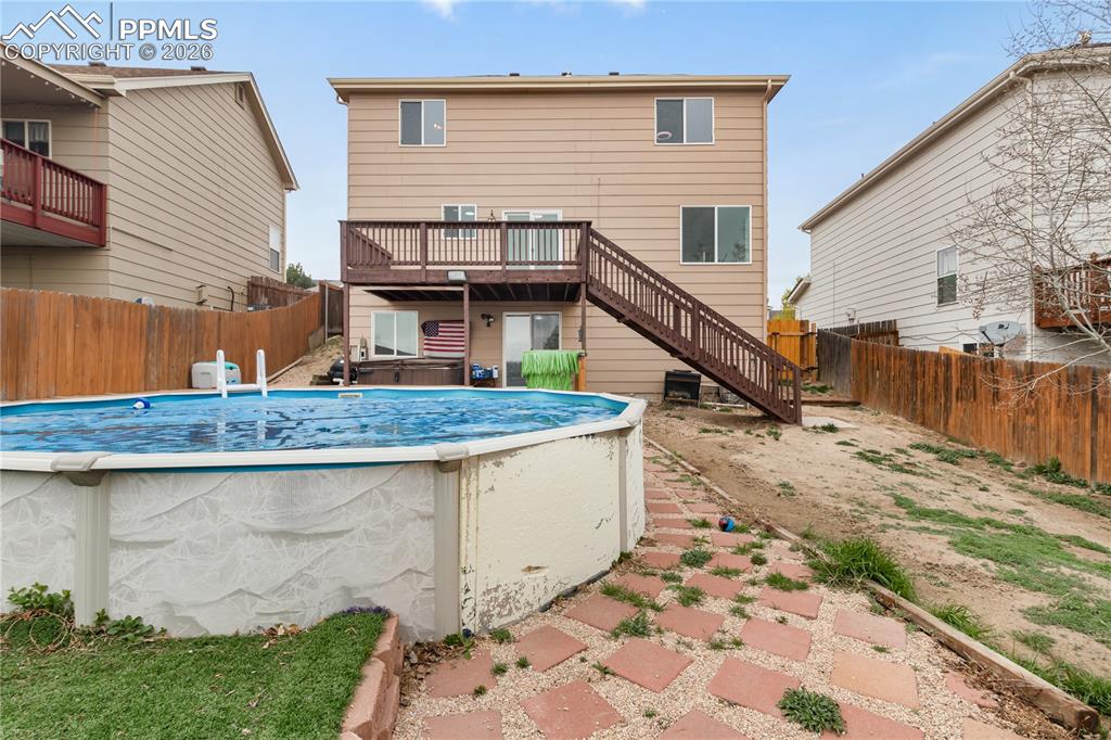 Image 39 of 43: The property features a backyard with an above-ground swimming pool, a tier