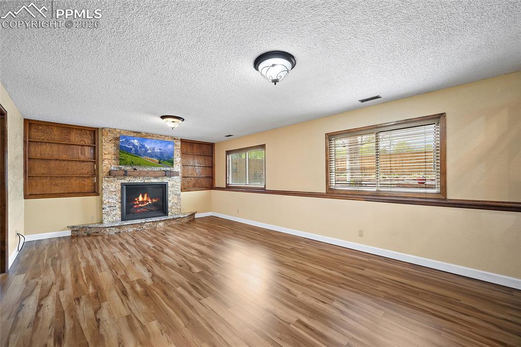 Image 25 of 50: Beautiful custom stone fireplace with top of the line Gas fireplace. 