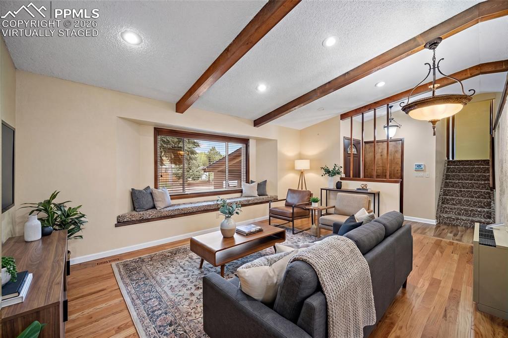 Image 4 of 50: virtually staged with built in window seat and beamed ceilings!