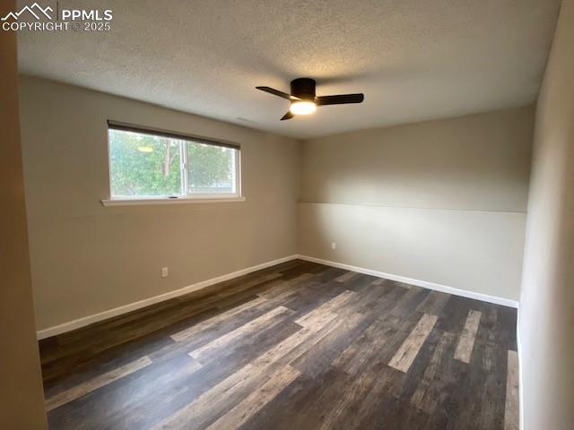 Image 13 of 26: Empty room featuring a ceiling fan, a textured ceiling, dark wood-type floo