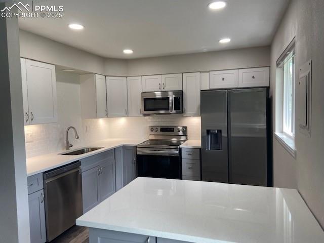 Image 5 of 26: Kitchen featuring appliances with stainless steel finishes, a sink, light c