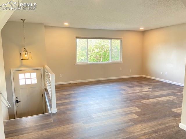 Image 6 of 26: Entrance foyer with a textured ceiling, healthy amount of natural light, wo