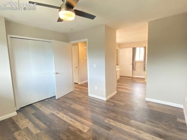 Image 8 of 26: Unfurnished bedroom featuring wood finished floors, baseboards, and a close