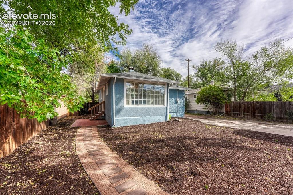 Image 37 of 44: Exterior featuring a stucco finish, multi-pane windows, a fenced perimeter,