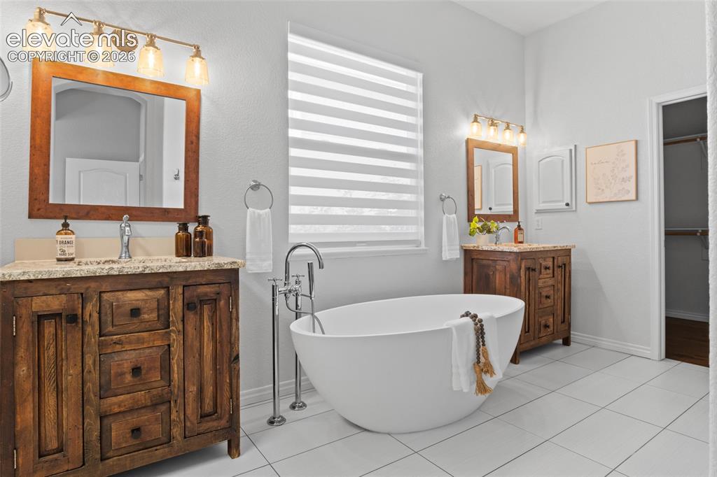Image 22 of 44: Updated Primary Spa Like bathroom with beautiful soaker tub, custom walk-in