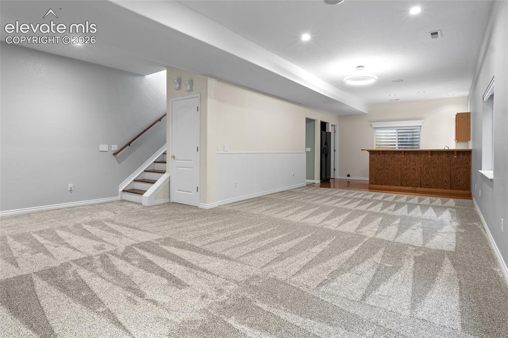 Image 28 of 50: Expansive Lower Level Family room with near new luxury carpet