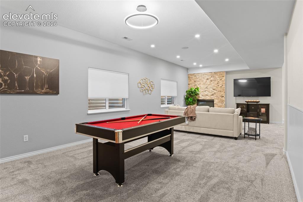 Image 30 of 44: Lower Level Family room/Game room features new Luxury carpet, paint, Lutron