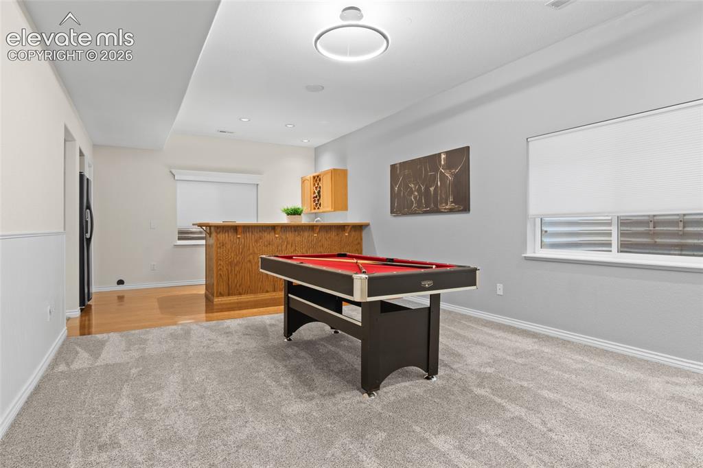 Image 31 of 44: Walk up wet bar with party friendly flooring for entertaining friends or fa